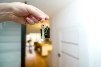 A hand handing the key.