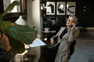 A woman talking on her phone in the office.