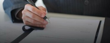 A man signing a contract.