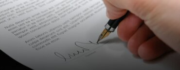 A man signing a contract.